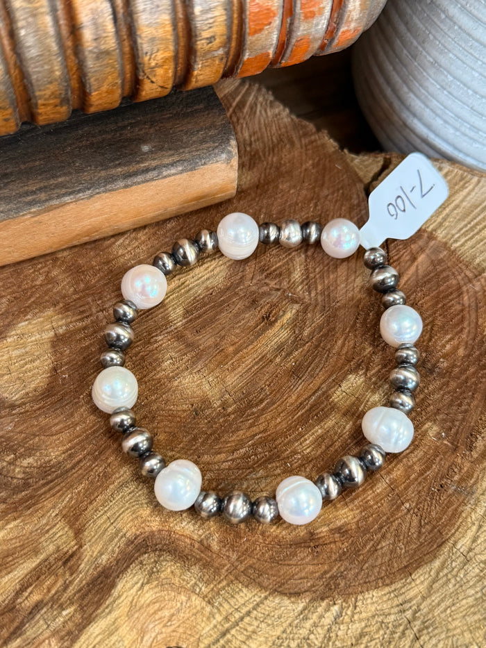 Stretchy 7 in freshwater pearl bracelet with iridescent white pearls and silver spacer beads