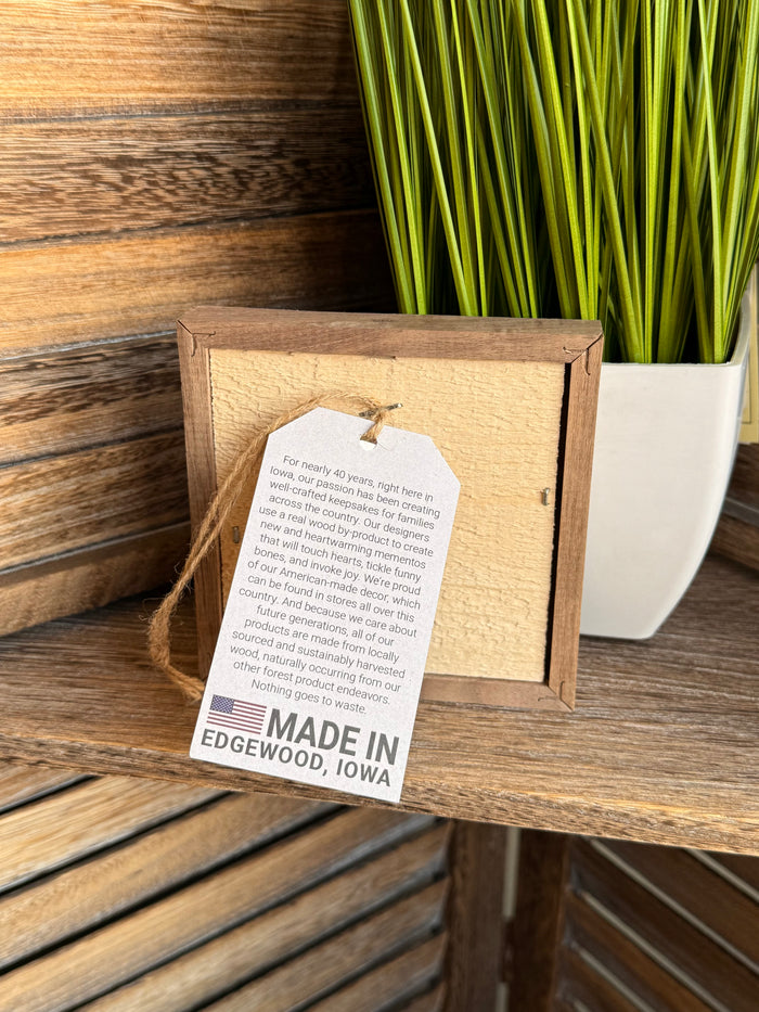 Wood-framed sheet music back with twine hanger and "Made in Edgewood, Iowa" label