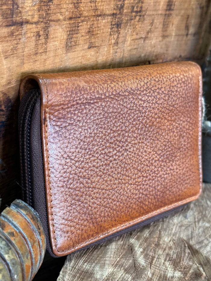 Brown cowhide zip coin wallet with zipper, textured finish and side profile