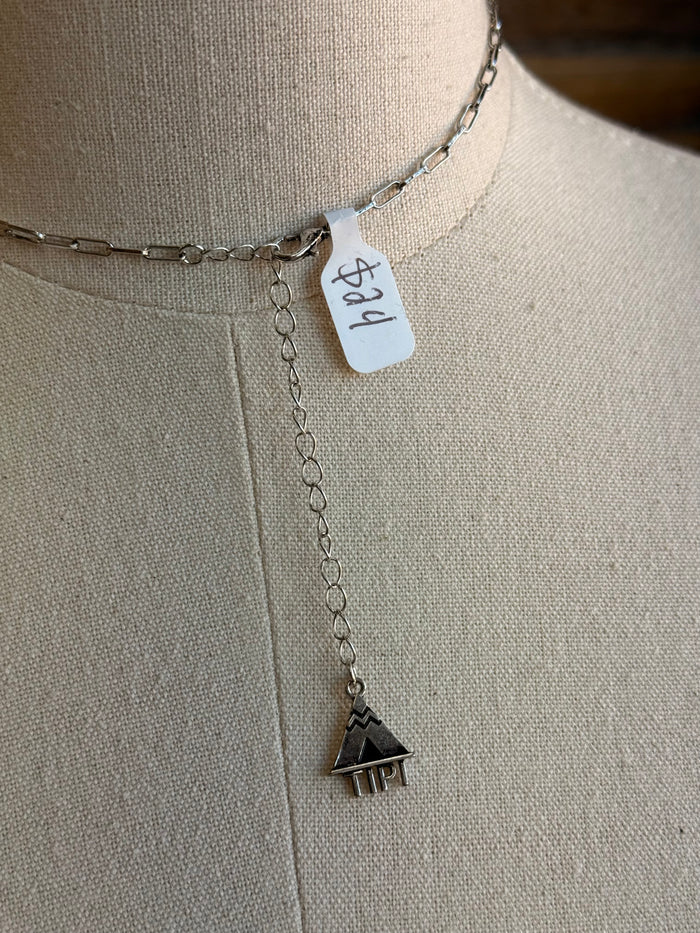 Silver-tone necklace chain with heart-shaped charm and “Ranchin’ Mama” tag
