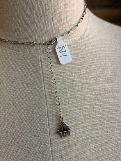 Silver-tone necklace chain with heart-shaped charm and “Ranchin’ Mama” tag