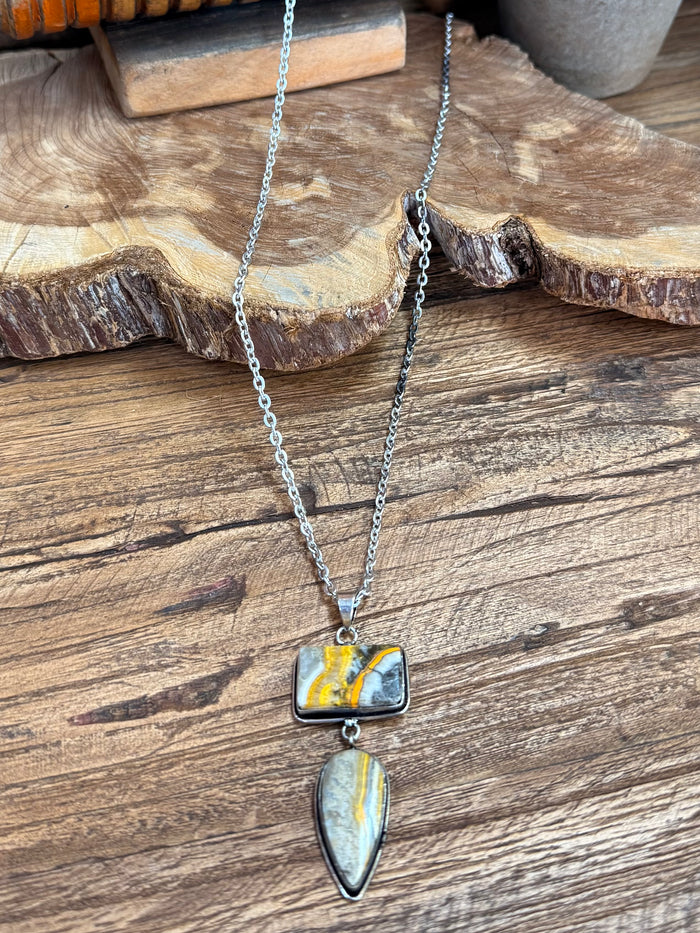 Silver chain lariat necklace with rectangular yellow-blue pendant and teardrop charm