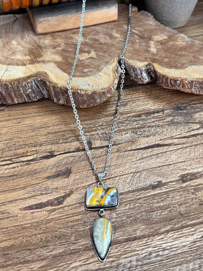 Silver chain lariat necklace with rectangular yellow-blue pendant and teardrop charm