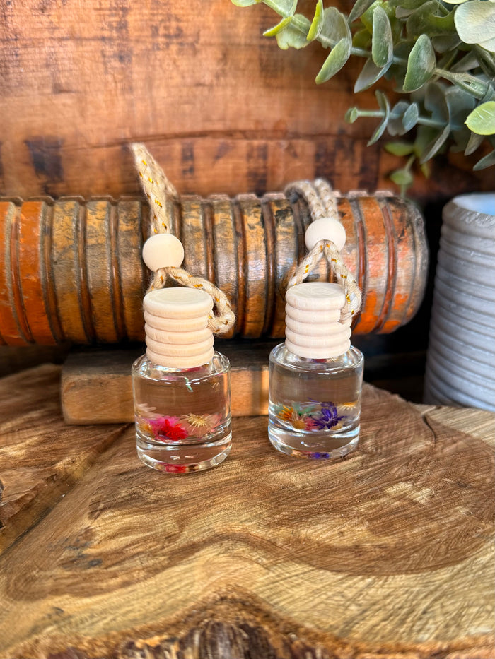 Set of two mini reed diffusers with clear bottles and white stacked reed caps