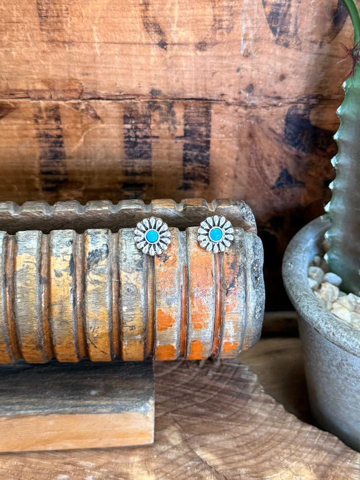 Silver-tone concho stud earrings with turquoise round centers in floral sunburst frames