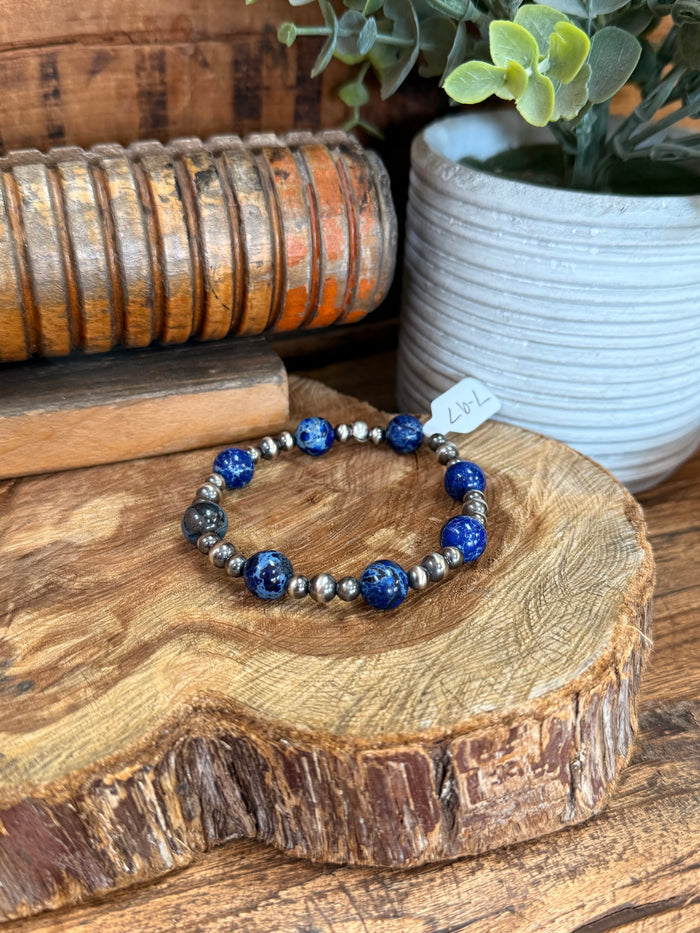 Stretchy bracelet with dark blue jasper beads and silver pearl spacers