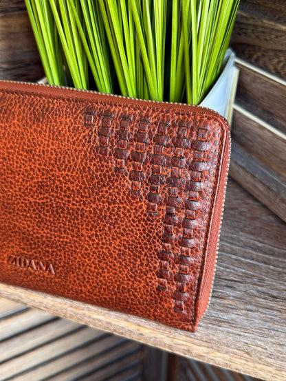 Rusty brown leather wristlet wallet with embossed pattern and stitched side zipper track