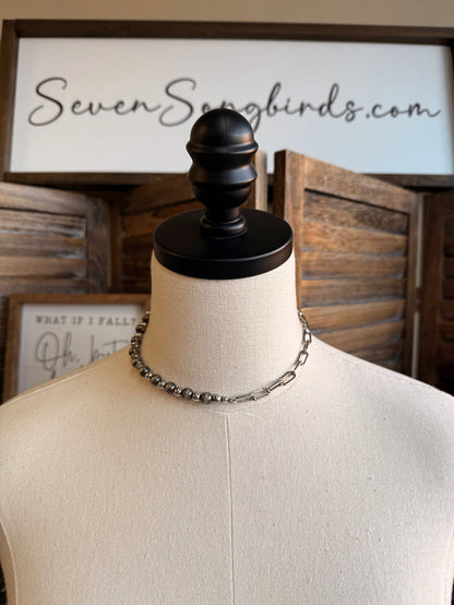 Silver chain and pearl bead necklace with layered links on a mannequin