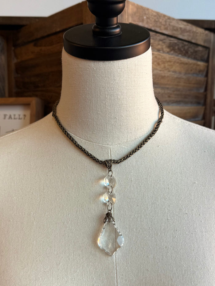Silver-tone chain necklace featuring crystal teardrop pendant with layered drop charms