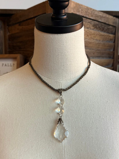 Silver-tone chain necklace featuring crystal teardrop pendant with layered drop charms