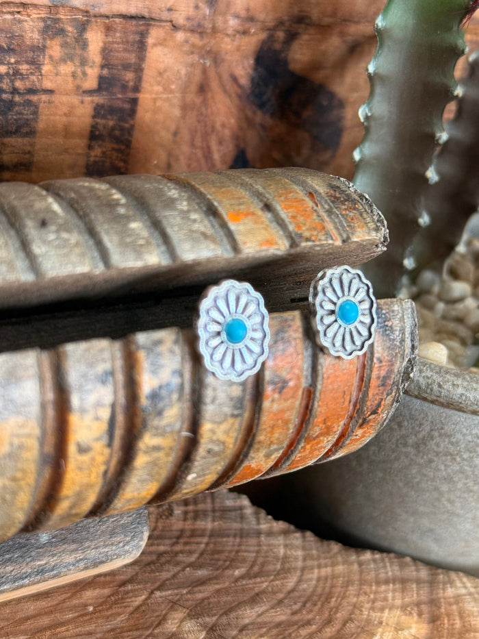 Silver concho stud earrings with turquoise enamel centers and detailed petal edges