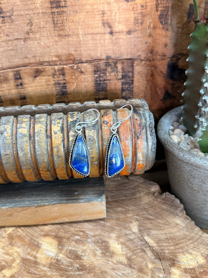 Silver-plated fishhook earrings with blue teardrop lapis stone and rope bezel