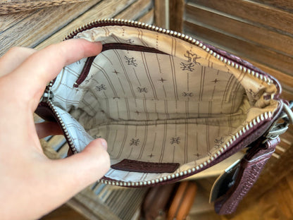 Mini wristlet bag interior with patterned lining and zipped opening