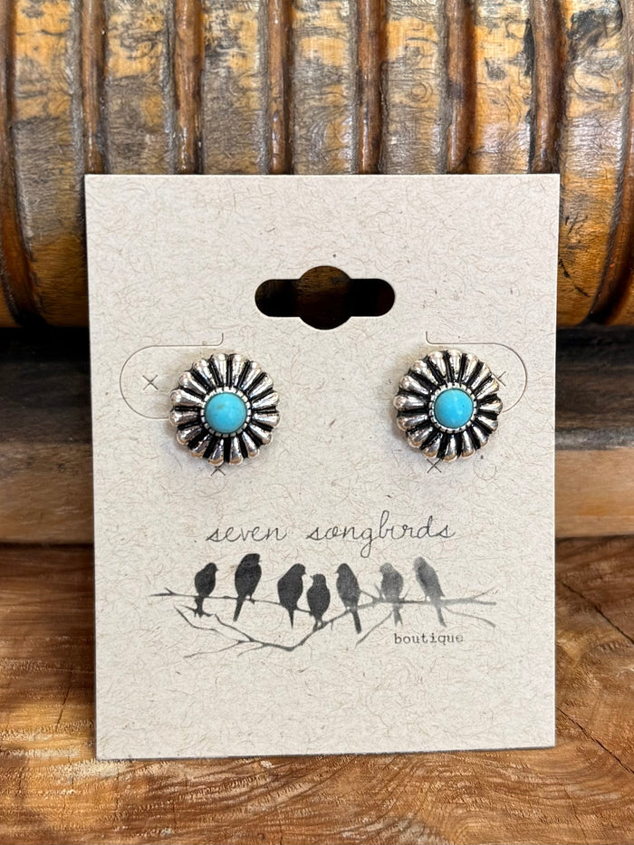 Turquoise daisy stud earrings, silver-tone circular flower settings, shown on card