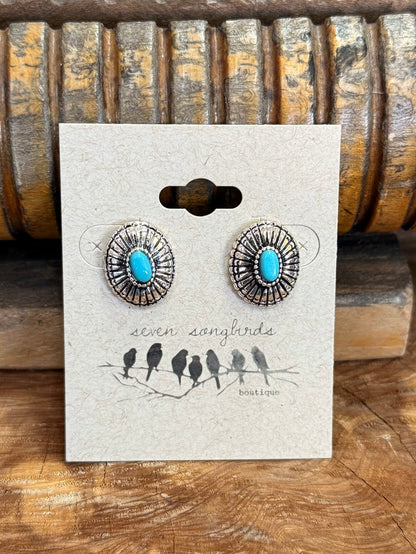 Round silver concho stud earrings with turquoise cabochon centers and detailed filigree