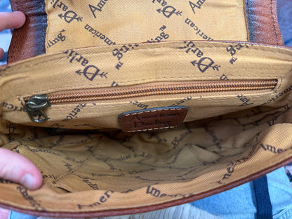 Crossbody bag interior lining with zipper pocket and brand patch on the inside