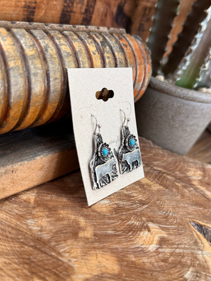 Silver cow tag fishhook earrings with turquoise bead dangles and engraved cow scenes