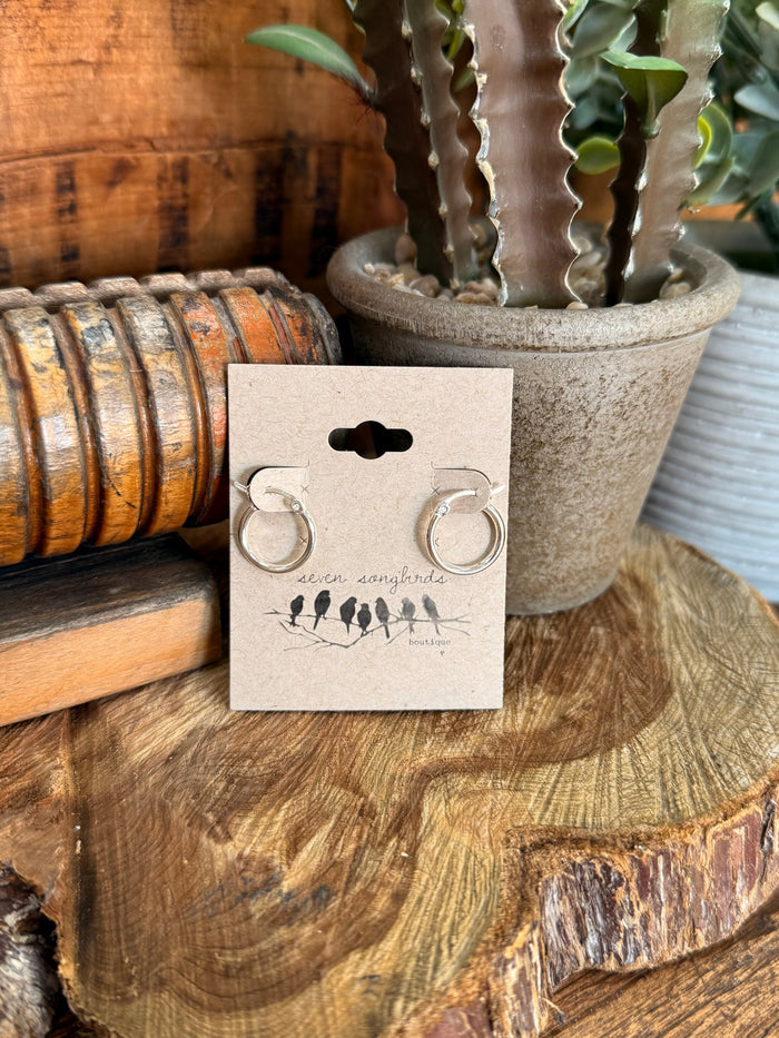 Silpada sterling silver round hoop earrings displayed on a gift card