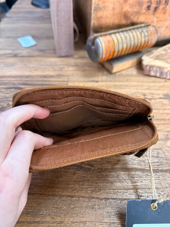 Brown cowhide double-zip coin wallet interior lining visible from open top
