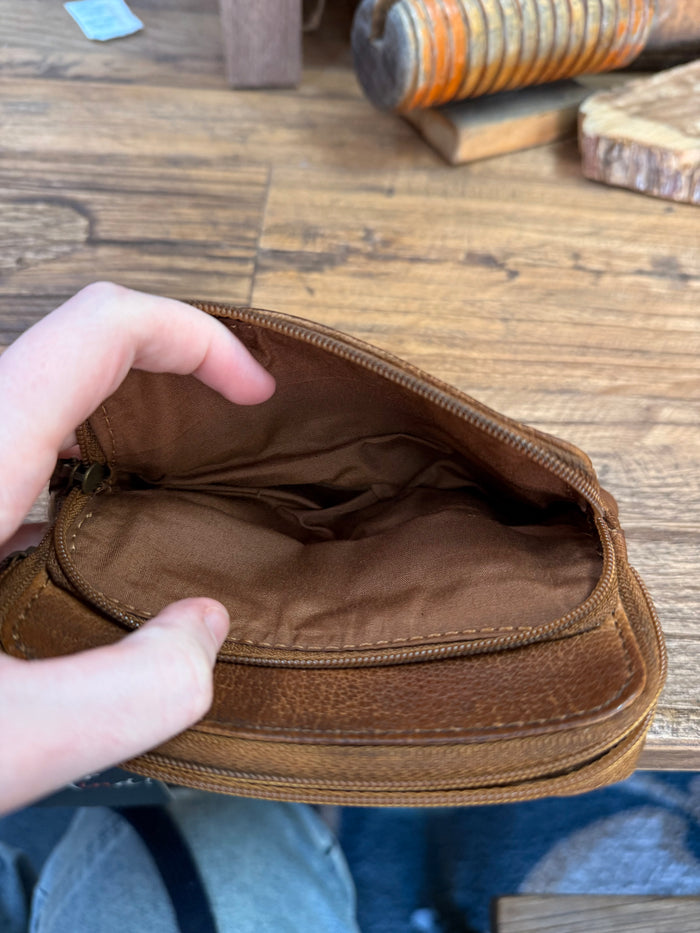 Brown cowhide coin wallet interior with stitched lining and zip closure details