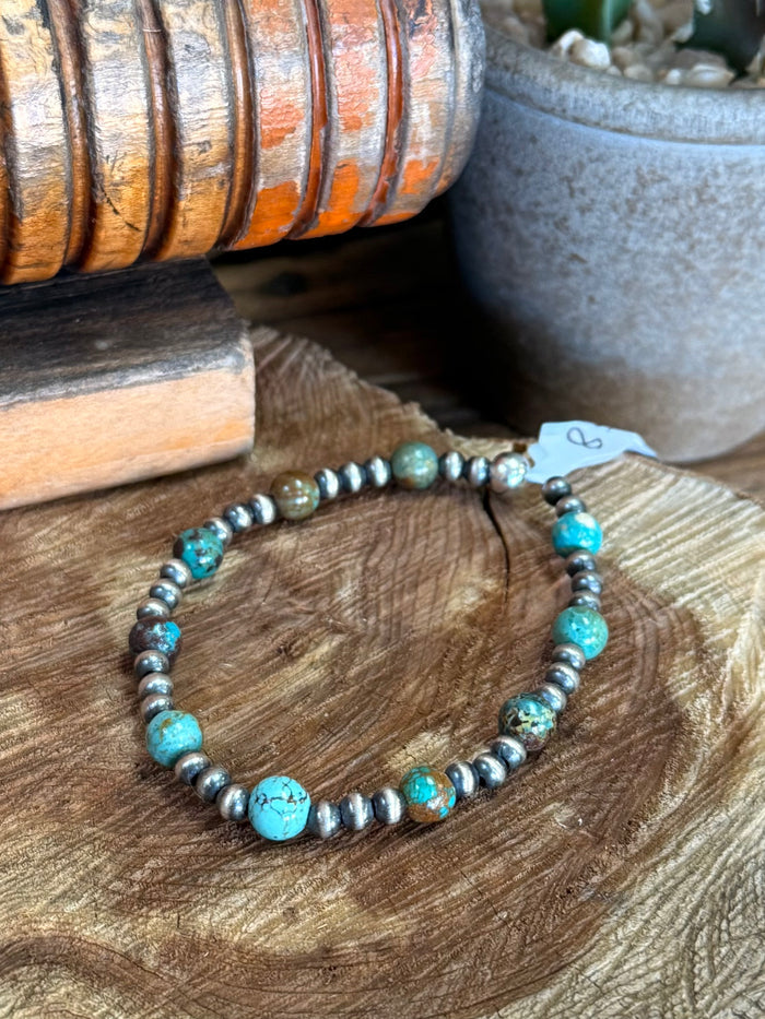 Turquoise and silver-tone bead stretchy bracelet with small hanging tag