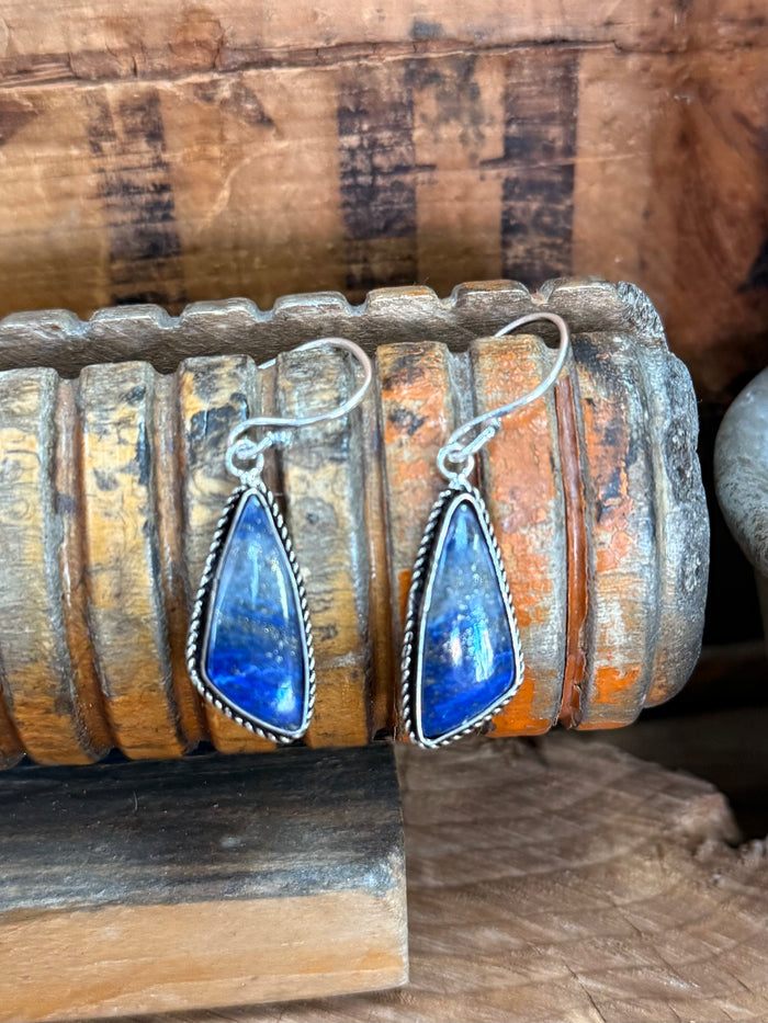 Pair of silver-plated fishhook earrings with blue teardrop lapis stones and rope bezels