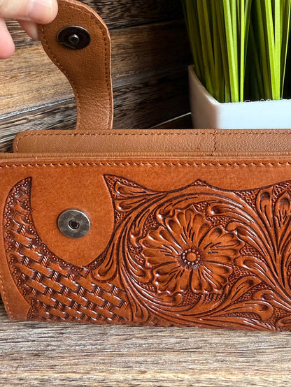 Tan leather wallet with snap closure and floral tooling on the front panel