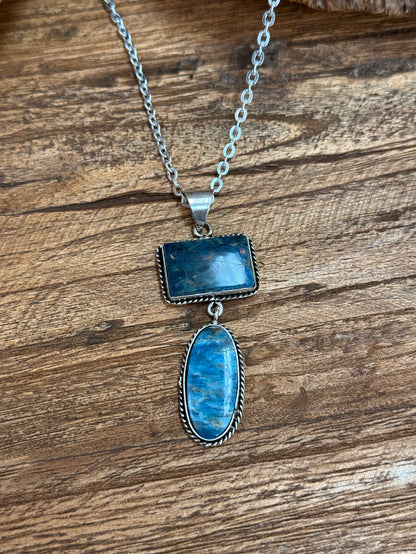 Silver chain lariat necklace with blue rectangular and oval stone pendants