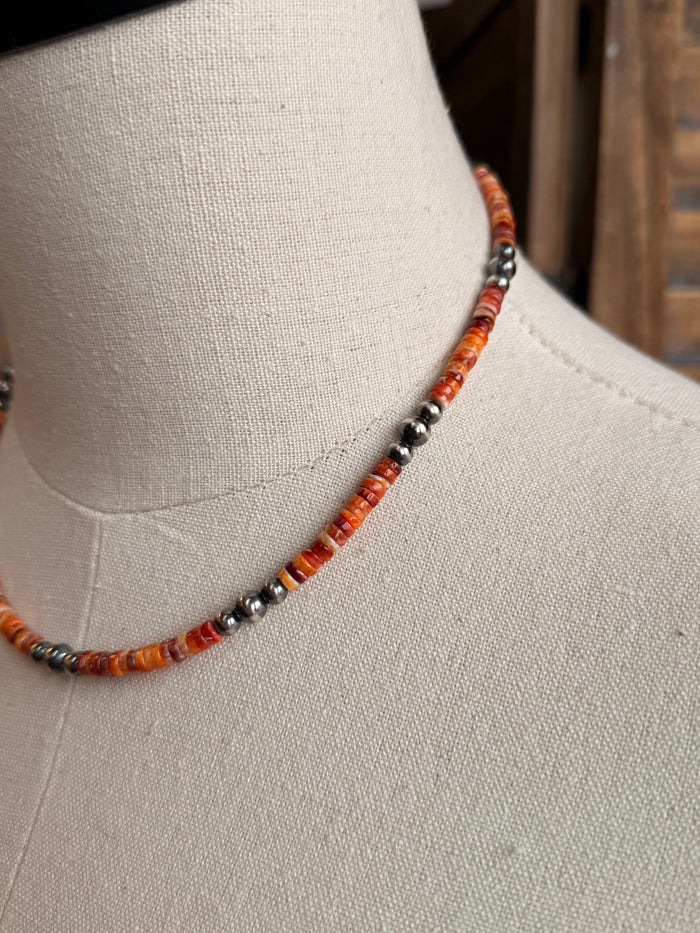 Orange heishi bead necklace with small silver spacer bead detail