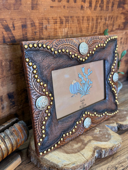 Angled faux leather 4x6 frame with concho details and blue floral center