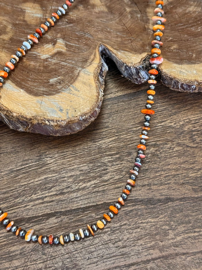 Orange spiny oyster chip necklace with sterling silver beads and small multicolor stones