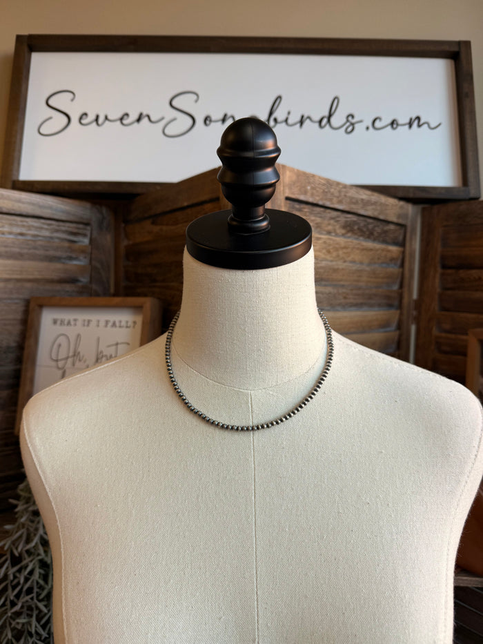 16-inch sterling silver beaded necklace on mannequin, flat chain with fine sheen