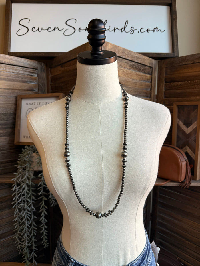 Mixed silver pearl bead necklace on a mannequin, long layered bead strand design