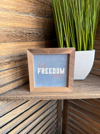 4x4 framed artwork with blue print and wooden frame, “Let FREEDOM ring” text