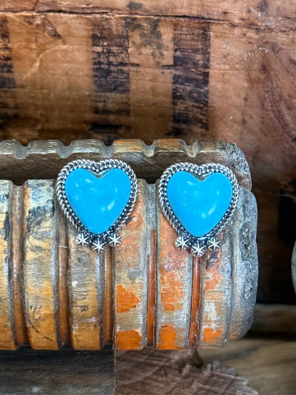 Large turquoise heart stud earrings in silver frames with hanging star-like charms