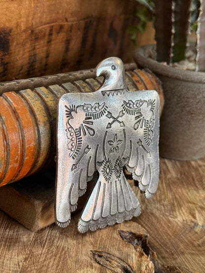 Thunderbird-shaped belt buckle, engraved silver metal with raised head and wings