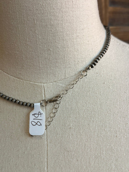 Silver pearl necklace with square hangtag marked '18' and small extender chain