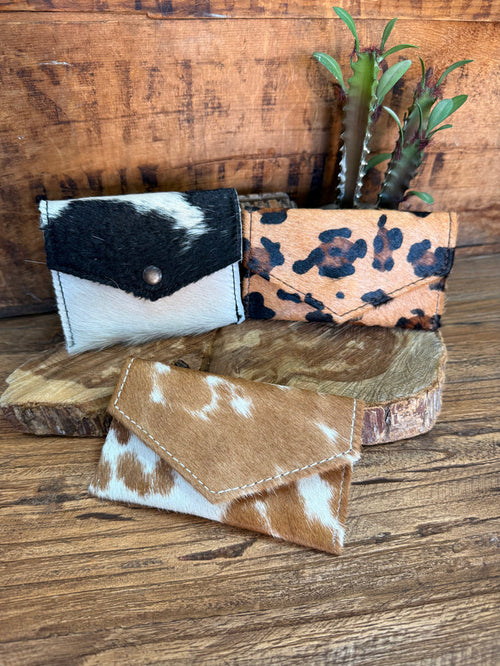 Set of three hair-on envelope wallets: black/white, leopard, brown/white hide.