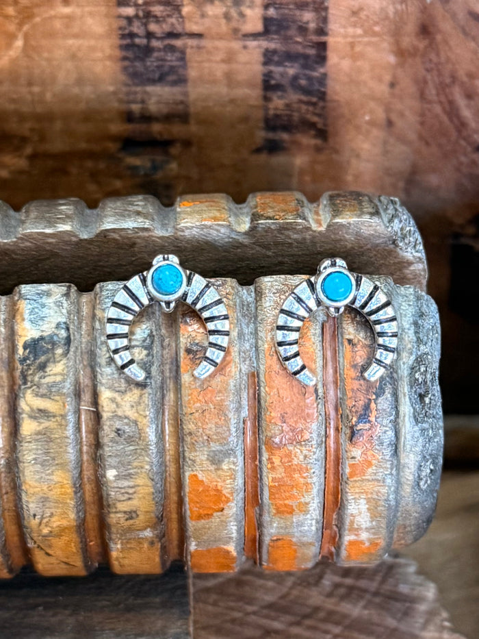 Pair of silver naja stud earrings with turquoise round stones and radial etched arcs