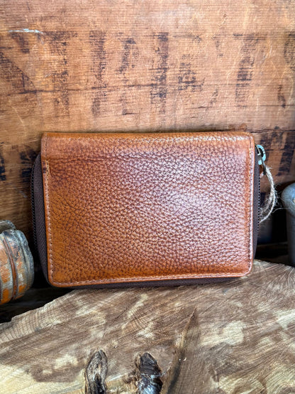 Brown cowhide zip coin wallet with textured leather and metal zipper pull
