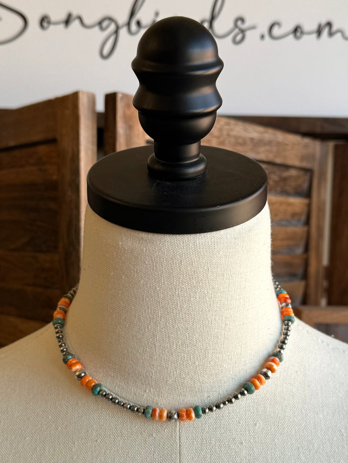 Turquoise and orange beaded necklace with silver-tone spacing