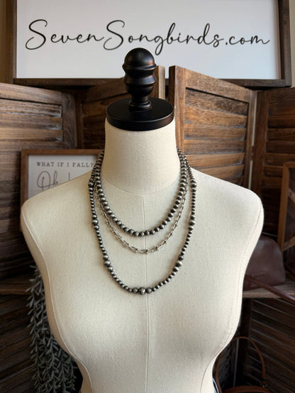 Triple pearl stack necklace with silver-tone beaded chain, layered three-row design