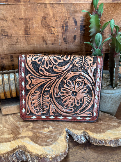 Tooled cowhide wallet with stamped floral pattern and contrast stitching, front view
