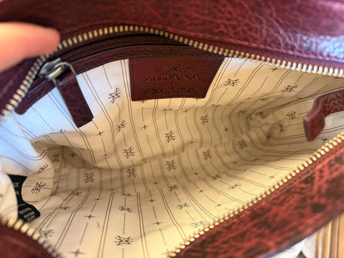 Plum crossbody bag interior lining with patterned fabric and gold-tone zipper
