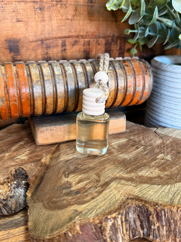 Mini reed diffuser with clear bottle, white stacked reed caps, and braided wick