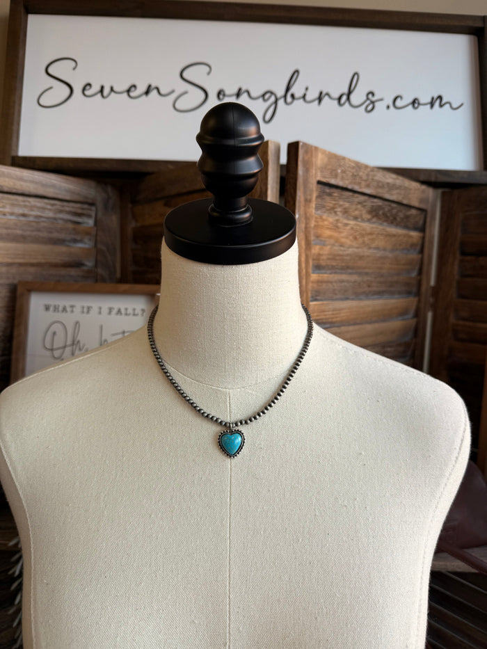 Turquoise heart pendant silver chain necklace on mannequin bust