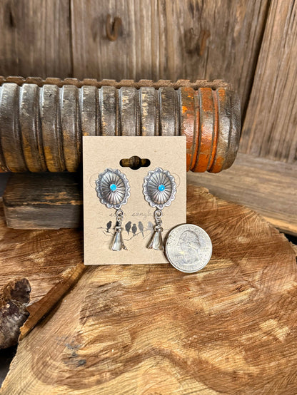Turquoise concho stud earrings with silver scalloped discs and bell charms, coin shown for size
