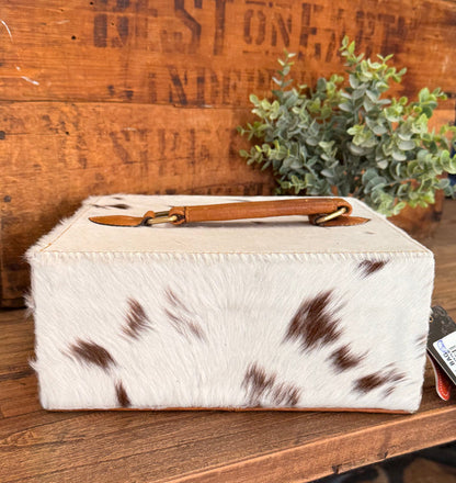 Hair-on cowhide jewelry box with tan leather strap and brown hide spots