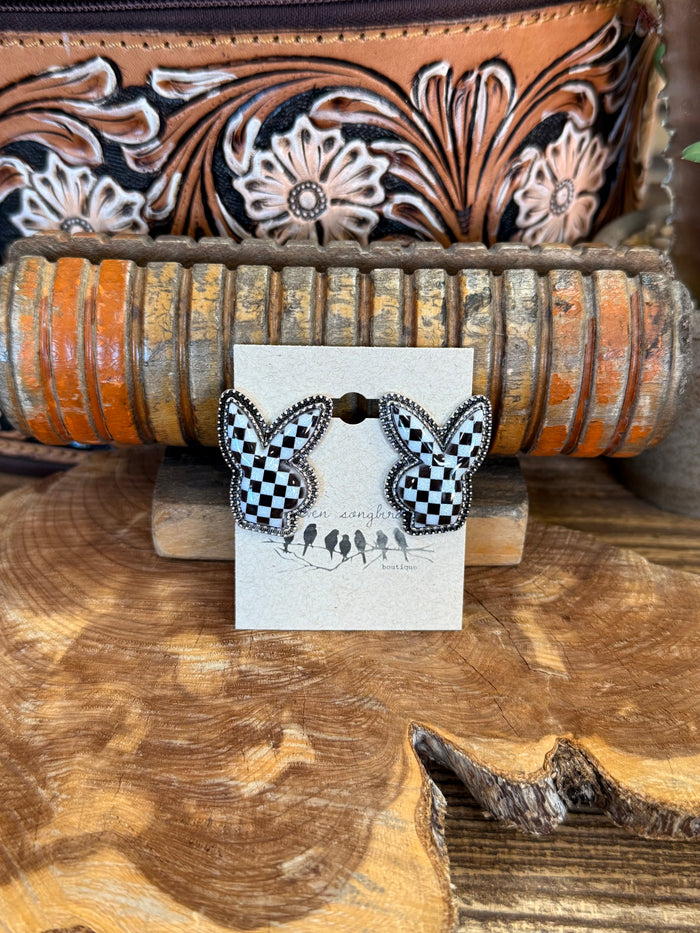 Black and white checkered rabbit stud earrings on display card
