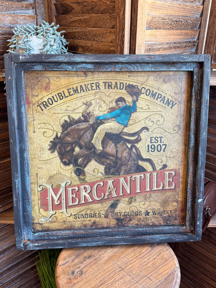 Vintage framed western artwork showing 'Troublemaker' banner, blue rider, Mercantile
